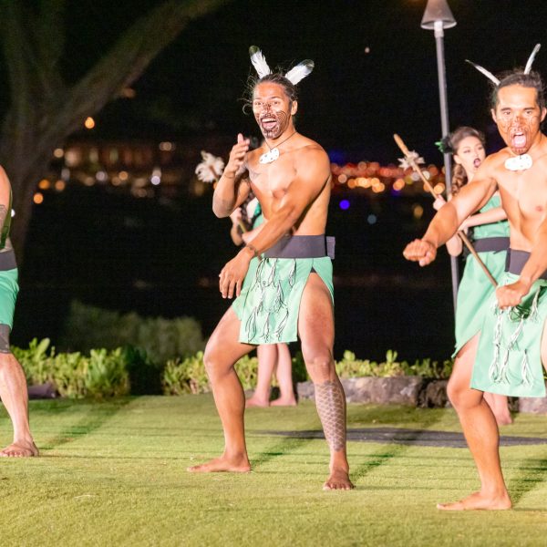 a group of people that are standing in the grass